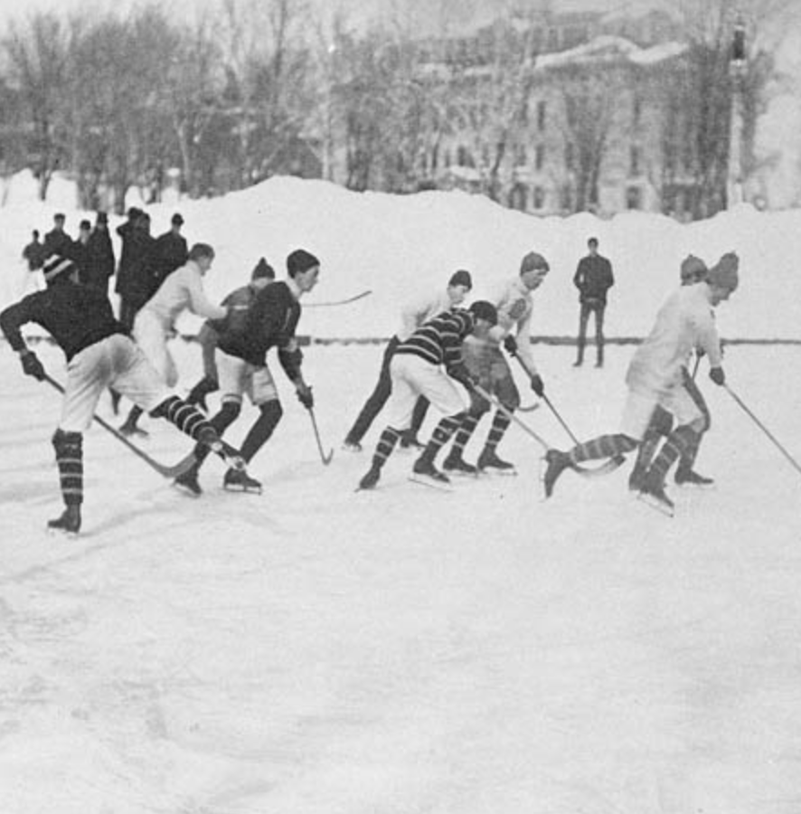 old black and white photograph of choldren playing hockey in old uniforms